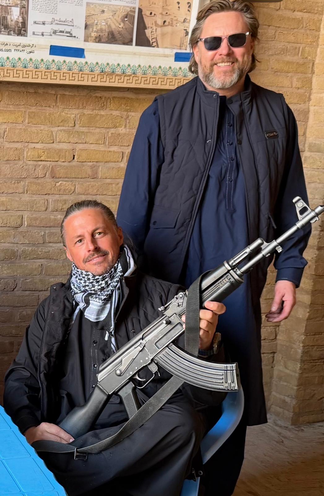 Ryan Bridge standing alongside a local security officer during a visit to Afghanistan.